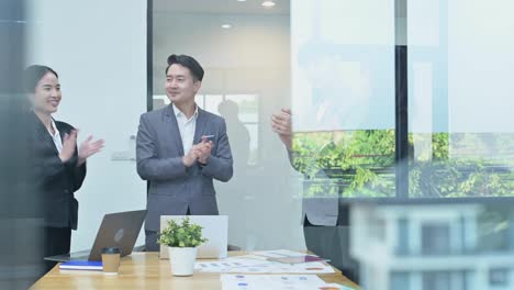 team of asian business people clapping and applause at meeting the annual sales of housing estate sales, success teamwork or corporate of real estate