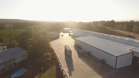 A-large-truck-transporting-many-crates-arrives-at-a-warehouse