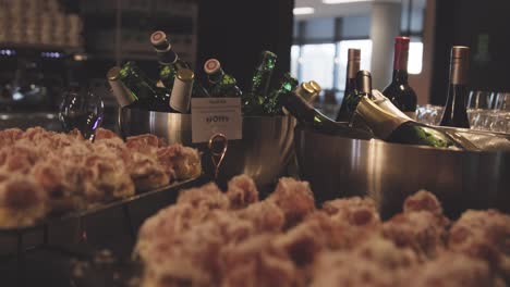 catering table filled with alcoholic drinks and tasty finger food appetizer, close up