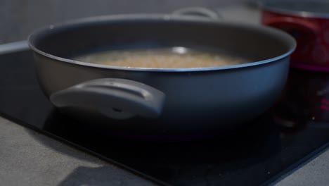 close up of a pan on a stove with oil in it