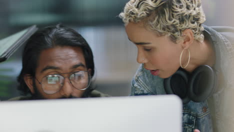 young business people brainstorming using digital computer pointing at screen sharing ideas discussing project strategy showing support in diverse office meeting