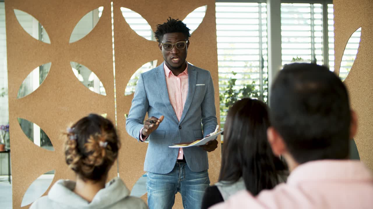 Handsome African American man talking during presentation
