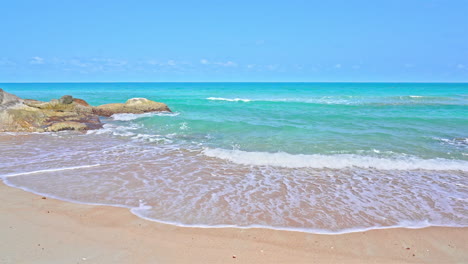 empty white sand beach and emerald tranquil sea foamy tides, cloudless sky, vacation template, copy space minimalistic