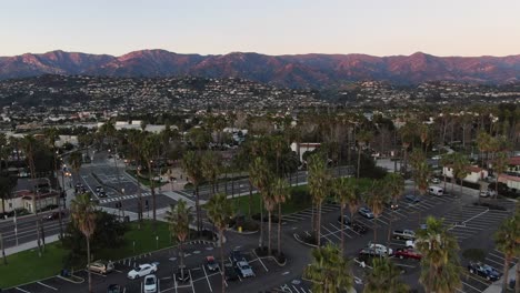 aerial shot ascending and palm trees in california beach parking lot