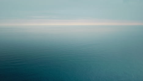Vast Blue Ocean Meeting the Hazy Sky