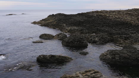 mysterious waterside scenery of waves hitting the rocky coastline