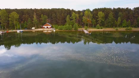 Aerial-Shot-of-Lake-Wdzydze-Shore-Line-at-Sunset