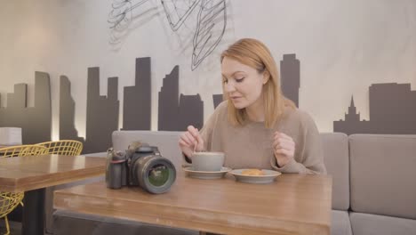 woman enjoying coffee and pastry in a cafe