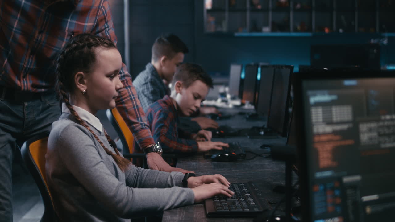 Teacher assisting student in coding class