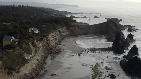 Aerial:-Oregon-coastline,-low-tide-at-Seal-Rock-beach,-dramatic-stormy-coast