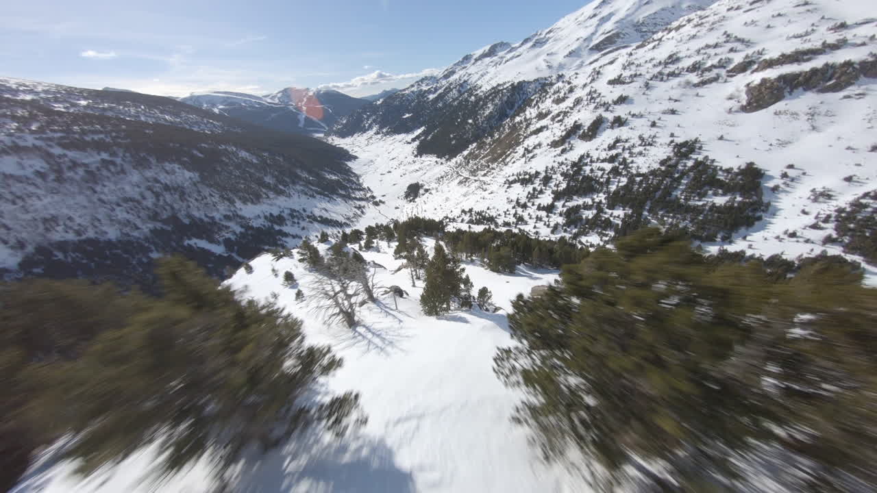 Crazy racing drone flying over snowy landscape of Pyrenees mountains