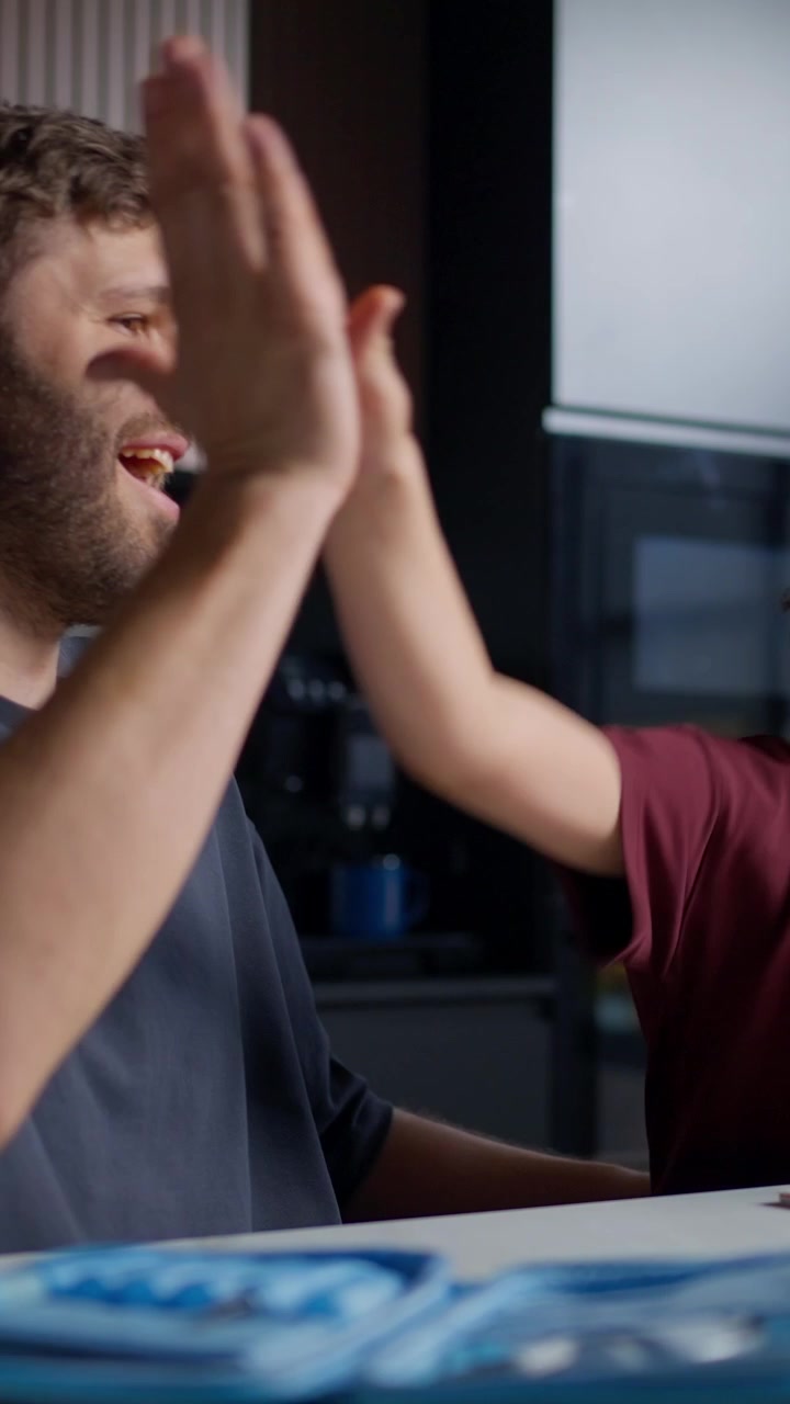 Happy Father and Son High-Fiving After Finishing Homework