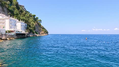 calm sea with coastal cliffs and distant mountains