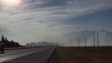 Highway-with-smoke-from-fire-close-to-mountains