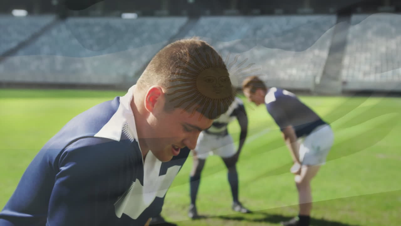 Strategizing on field, rugby players in blue uniforms during match