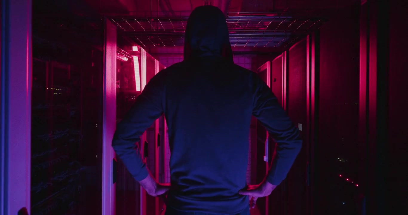 Hacker in a Server Room at Night