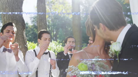 wedding couple kissing with friends blowing bubbles, over light leak animation