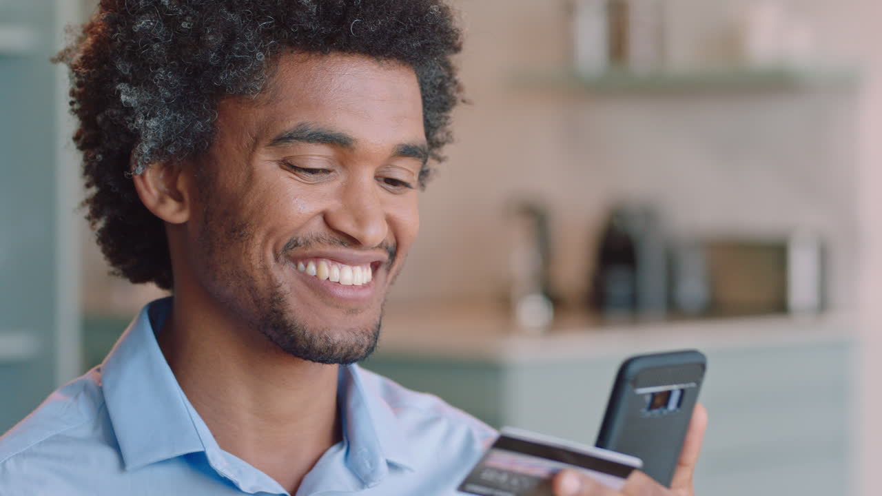 happy man using smartphone shopping online spending money on credit card mobile banking app with digital currency enjoying financial freedom