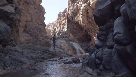 Hiker-inside-a-canyon-near-San-Pedro-de-Atacama-desert,-northern-Chile,-South-America