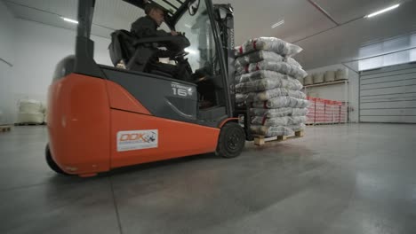 forklift loading pallets in a warehouse