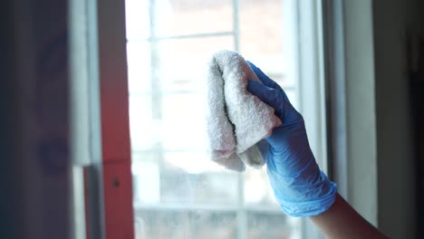 cleaning a window with a towel