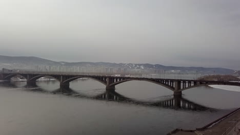 bridge over a river in a winter city landscape