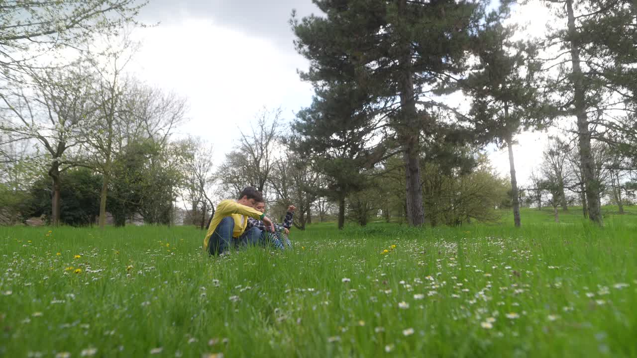 Two people sitting in a park