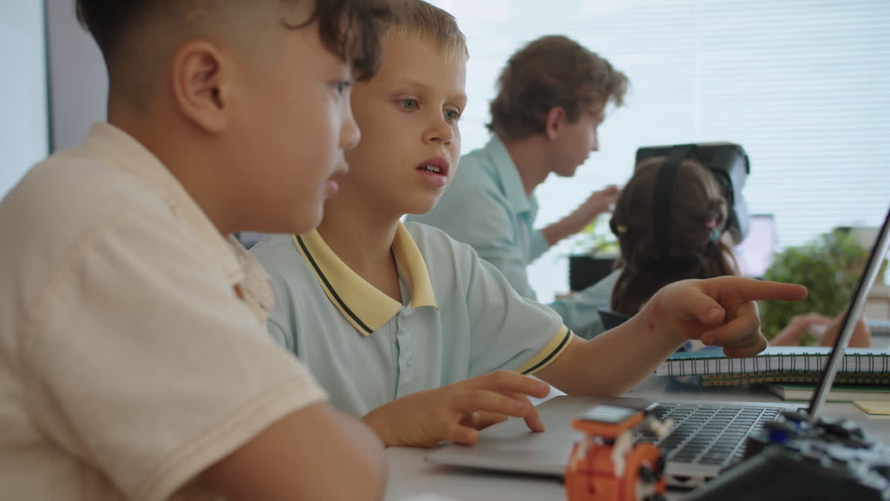 Boys Learning to Write Programming Code on Laptop at IT Class