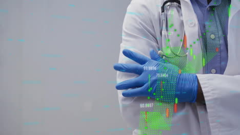 male doctor crossing arms in studio, displaying digital health charts and numerical data overlays