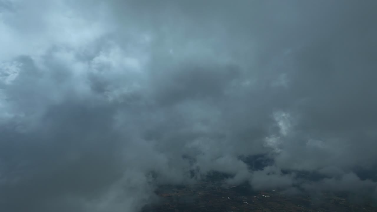 An immersive pilot’e eye view taken from the cockpit of a jet airplane flying peacefully through layers of broken ethereal stratus clouds in a blue sky. Ultra-realistic shot