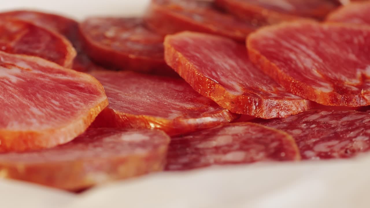 Mix of spanish pork sausages, Cutting board of appetizing catalonian snack - fuet, jamon, chorizo, olives, supermarket tapas food in spain, traditional cuisine.