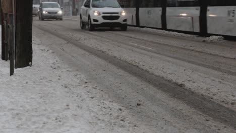 canada - cars driving in the snowy road on a cold winter day - closeup shot