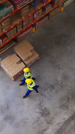 warehouse worker interacting with each other while walking