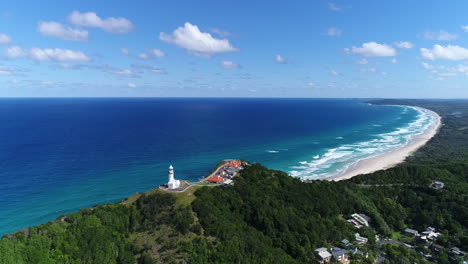 stunning aerial shot of the cape byron light house with amazing contrast with the blue ocean behind