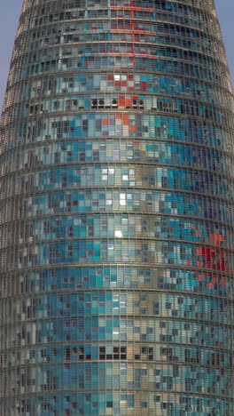 timelapse of the encants second hand market in barcelona and skyline behind in vertical