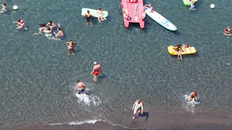 tourists enjoying water activities and swimming