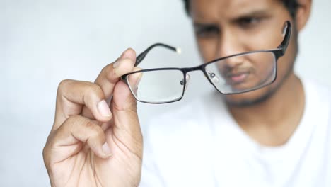 man holding glasses