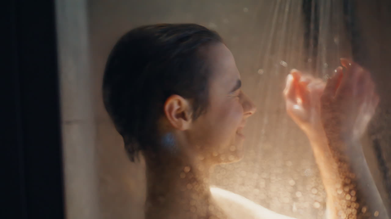 Carefree brunette dancing spa room portrait. Closeup girl showering washing hair