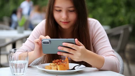 girl taking photo of cake with phone