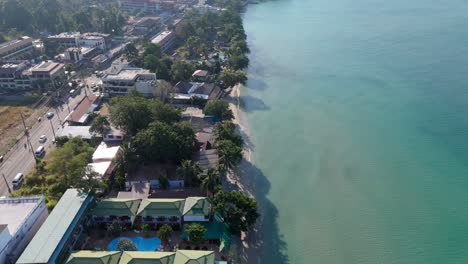 aerial drone footage of white sand beach village, koh chang, thailand. capturing sunny morning views of the coast and tropical scenery