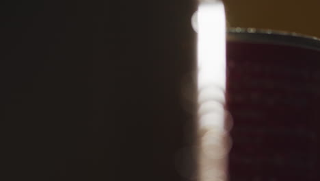 Close-Up-Backlit-Shot-Of-Condensation-Droplets-On-Revolving-Takeaway-Cans-Of-Cold-Beer-Or-Soft-Drinks