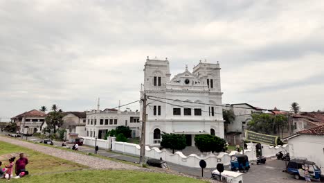 a picturesque scene showcasing the iconic meeran mosque in galle fort, sri lanka, with people walking by. capturing the blend of cultural heritage and daily life.