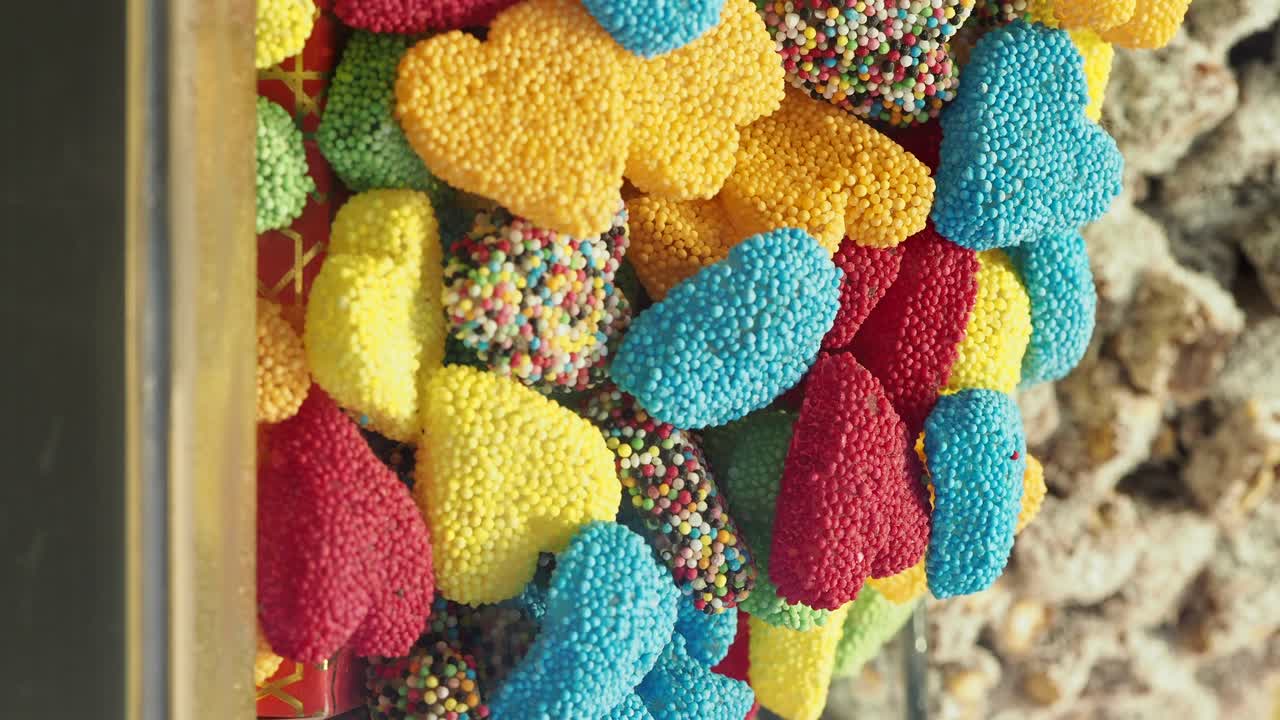 Assortment of Colorful Heart-Shaped Candies in a Dispenser