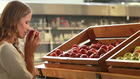 woman picking out fruit in supermarket