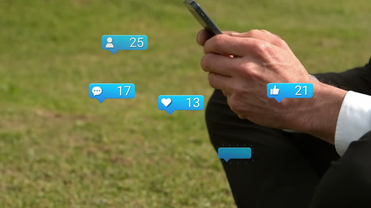 Animation of social media reactions over hands of caucasian man using smartphone