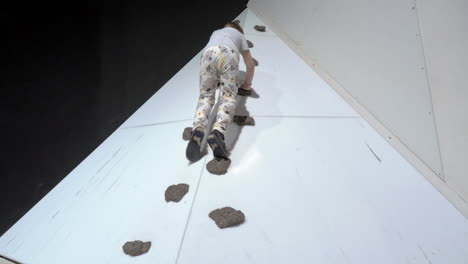 child on rock-climbing wall