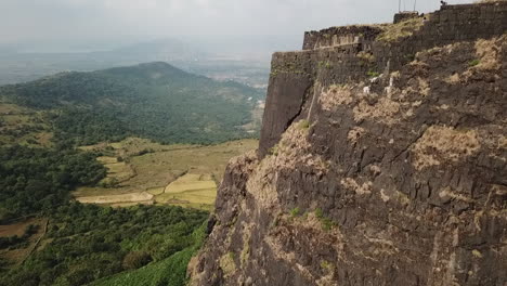 aerial flight to end of vinchu kada hill fort high above indian farms