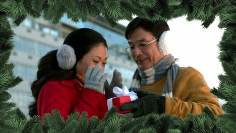 christmas tree border with couple giving gift