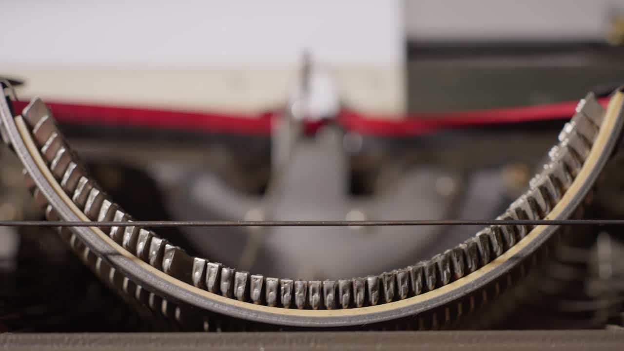 Detailed close-up view of the inner mechanics of a typewriter typing letters on paper