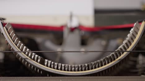 detailed close-up view of the inner mechanics of a typewriter typing letters on paper